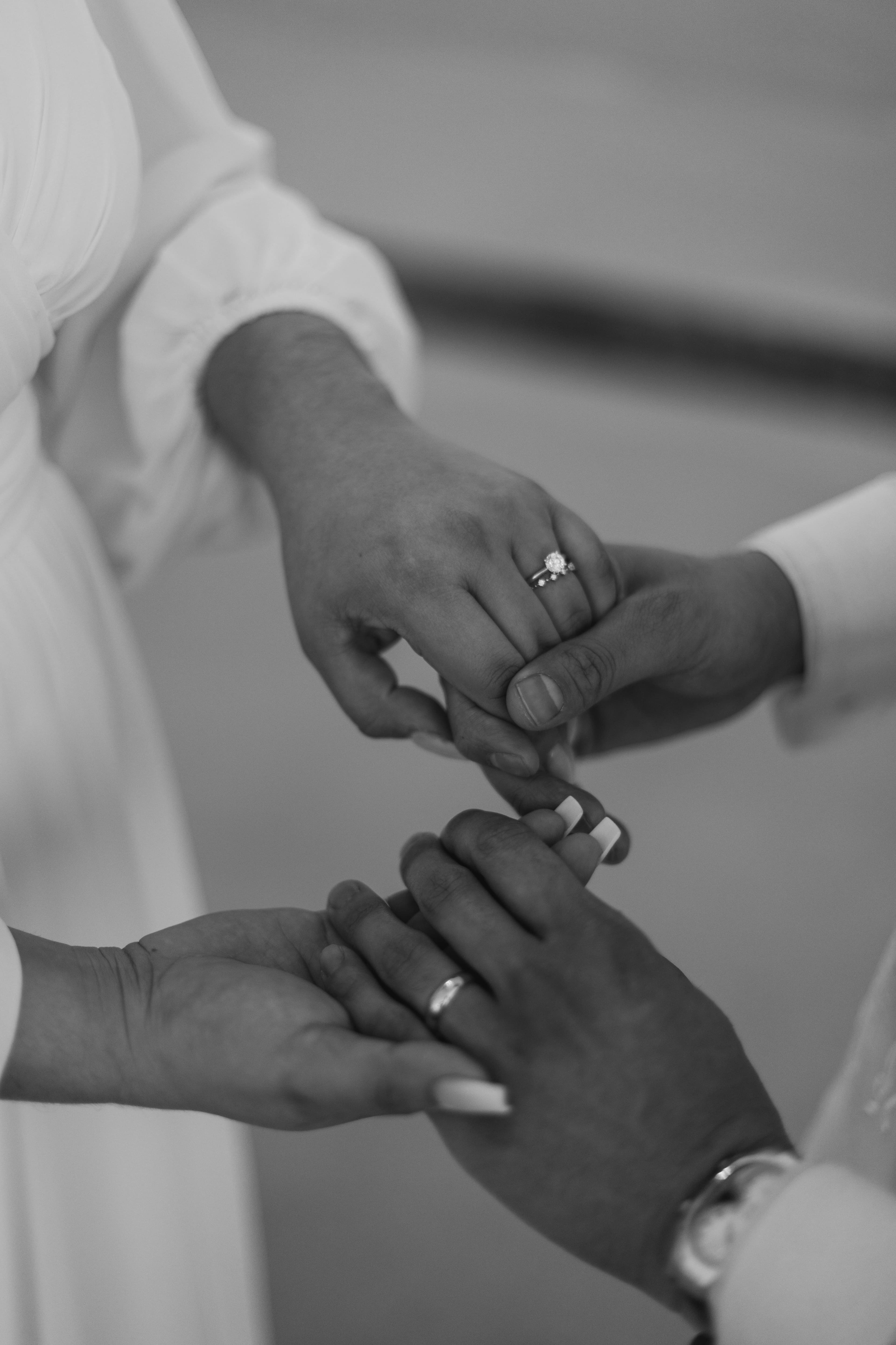Close up hands of couples with engagement ring